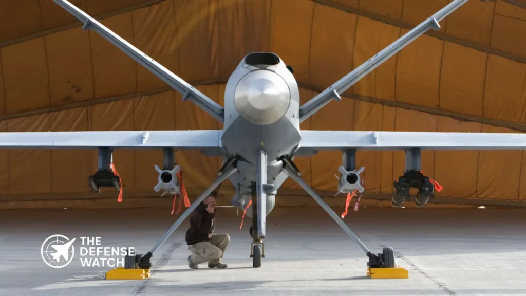 A General Atomics MQ-9 Reaper drone carrying AGM-114 Hellfire missiles on wing hardpoints during a combat air patrol mission.