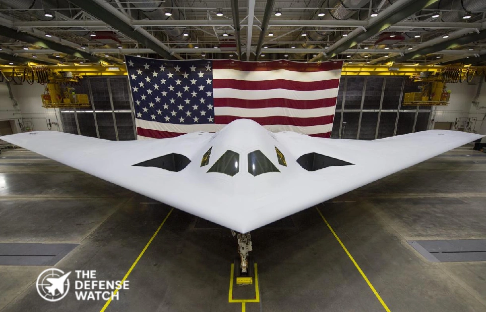 B-21 Raider stealth bomber unveiled in front of the U.S. flag in hangar
