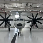 E-2D Hawkeye airborne early warning aircraft flying above U.S. Navy carrier