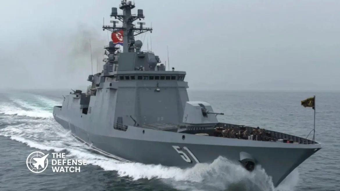 North Korean leader inspecting a newly unveiled nuclear-capable warship during a military ceremony at a naval shipyard.
