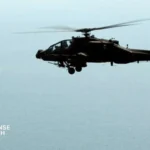 US Army AH-64E Apache and Navy MH-60R Seahawk flying in formation over the Persian Gulf.