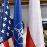 US and Polish military officials cutting a ceremonial ribbon in front of a newly constructed military storage hangar at Powidz Air Base.