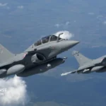 IAF Rafale and HAL Tejas Mk1A fighter jets in formation flight, showing both aircraft's underwing weapons loadout and Indian Air Force roundels.