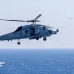 MH-60R Seahawk maritime helicopter flying near a New Zealand naval vessel during an anti-submarine and maritime security operation.