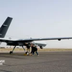 A General Atomics MQ-9 Reaper drone carrying AGM-114 Hellfire missiles on wing hardpoints during a combat air patrol mission.