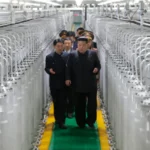 Kim Jong Un inspecting a newly inaugurated nuclear material production facility in North Korea during a visit focused on expanding nuclear weapons production.