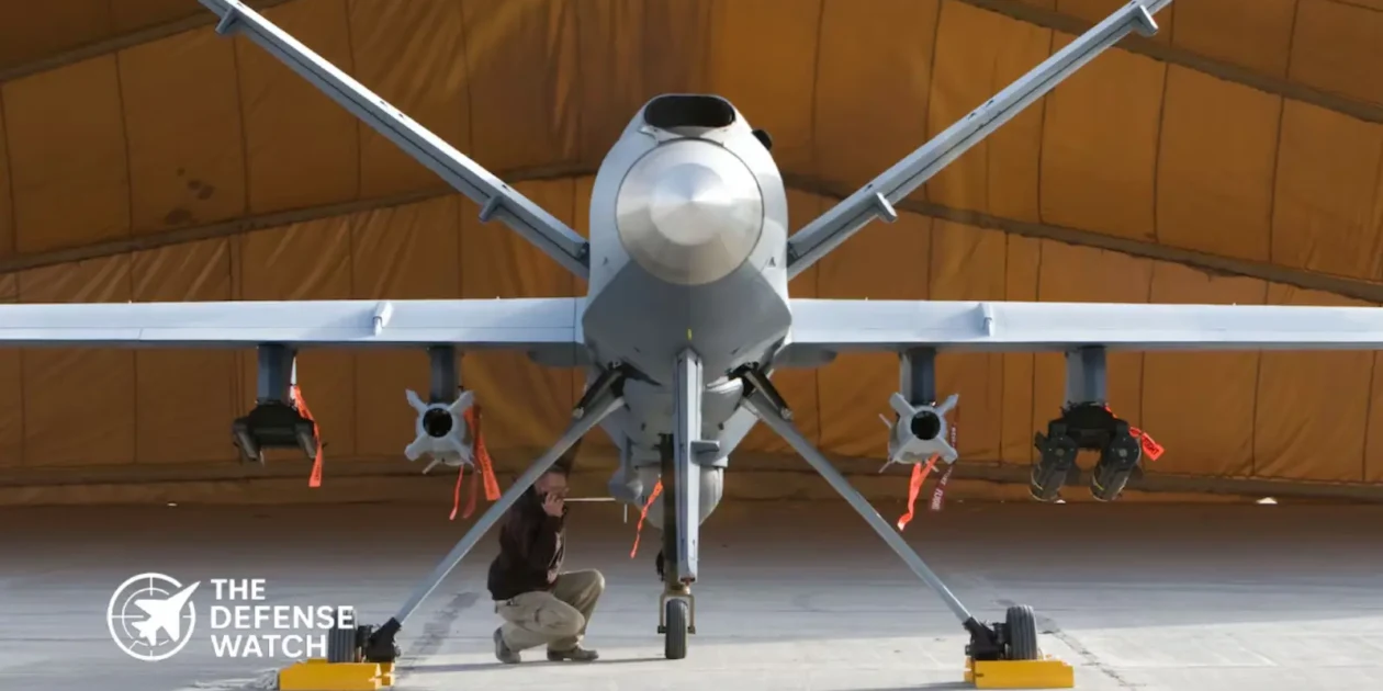 A General Atomics MQ-9 Reaper drone carrying AGM-114 Hellfire missiles on wing hardpoints during a combat air patrol mission.